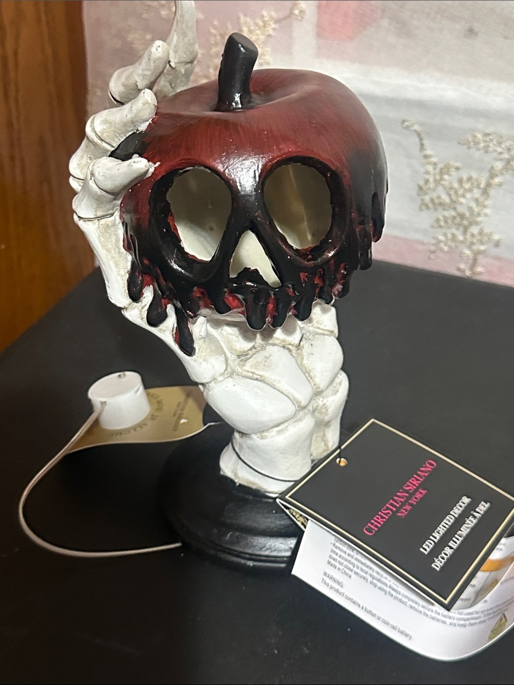 Christian Siriano skeleton hand with apple LED decor
